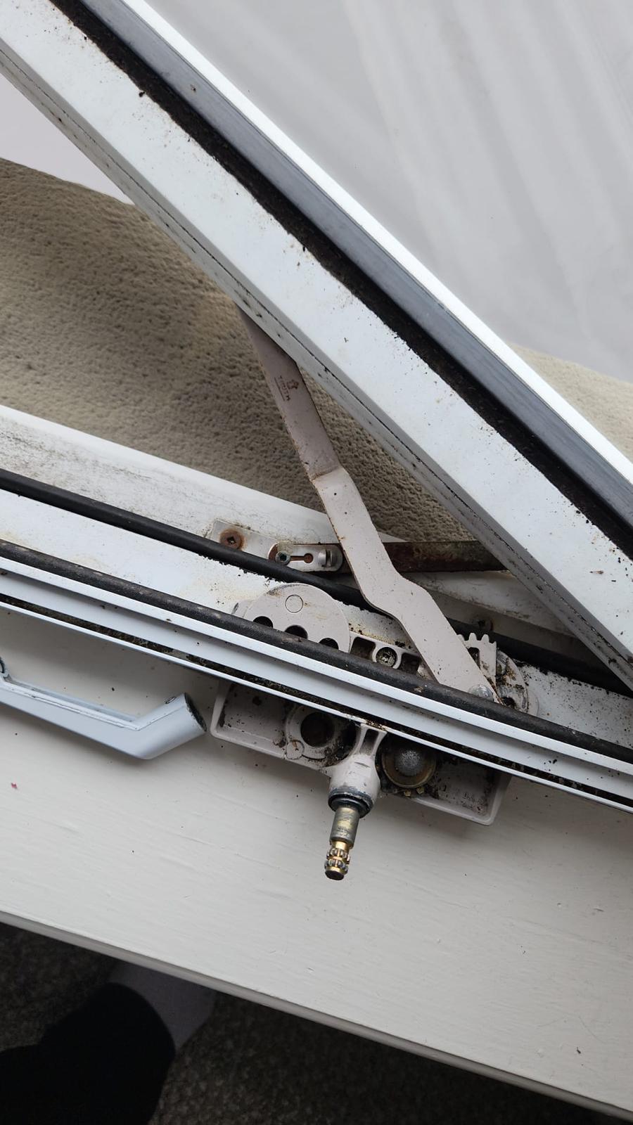 Worn and rusty window crank mechanism before professional repair - stripped gears and corroded hardware